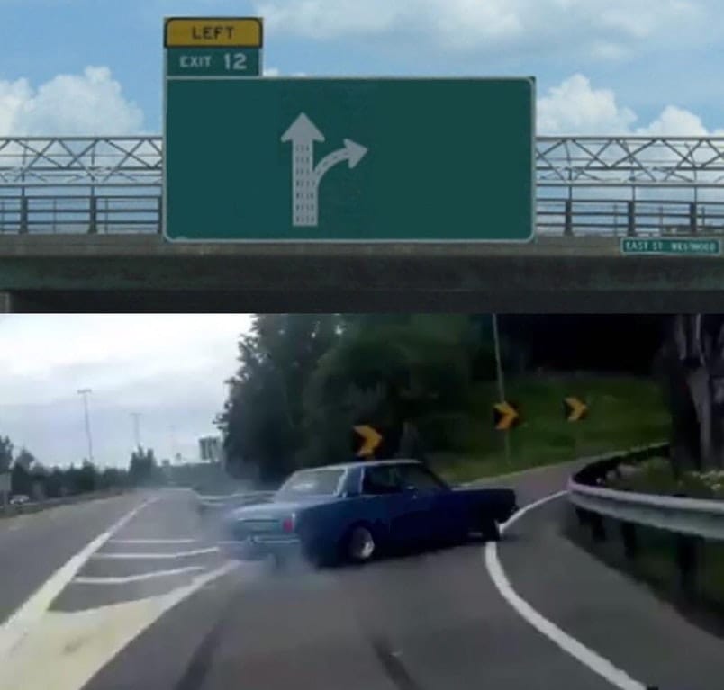 A car veering off a motorway towards an exit, seemingly at the last minute